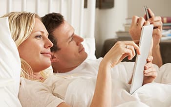 Couple performing their pre-donor questionnaire on their phone and tablet.